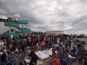 Carnival Triumph passengers waiting for the helicopter to make cargo deliveries. (Faraz Ismail photo)