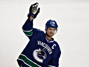 Vancouver Canucks Henrik Sedin waves to the spectators after he became the team's all-time highest scorer during their NHL hockey game against the Dallas Stars in Vancouver, B.C., Feb. 15, 2013. (REUTERS/Andy Clark)