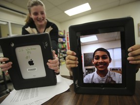 Students Kacey Bastien, 12, left and Javed Khan, 12, use J.G. Workman Public School's iPads. (JACK BOLAND/Toronto Sun)