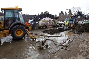 EPCOR crews continued to work on a water main break at 124th Street and 108 Avenue in Edmonton, Alta., on Saturday, February 16, 2013. The early morning break on Feb. 15 caused damaged to area businesses and homes. Ian Kucerak/Edmonton Sun/QMI Agency
