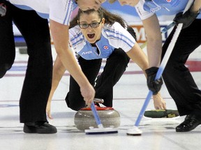 Brittany O'Rourke delivers a stone as her Quebec teammates prepare to sweep during Sunday morning's game versus Saskatchewan at the Scotties Tournament of Hearts in Kingston.