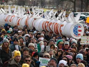 Demonstrators carry a replica of a pipeline during a march against the Keystone XL pipeline in Washington, D.C. on Feb. 17, 2013. (REUTERS)