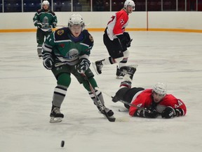 Welland Whalers John Williamson, left, beats Orillia Tundras defender Kyle Mont Petit to the puck in senior A hockey playoff action Monday at Welland Arena. JOE CSEH Tribune Photo