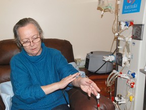 Kidney patient Maggie Morgan shows off the hemodialysis equipment provided to her by the Northern Alberta Renal Program (NARP) on Friday. Morgan is the only patient in Grande Prairie to use this kind of treatment, which allows her to clear toxins from her body at home rather than in a hospital. (Elizabeth McSheffrey/Daily Herald-Tribune)