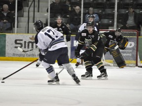 Terriers forward Regan Stire keeps an eye on Steinbach's Kyle Rous during Sunday's 2-1 Portage loss. The Pistons outshot the Terriers 38-24 and moved into second place in the Addison Division with the win. (Clarise Klassen/PORTAGE DAILY GRAPHIC/QMI AGENCY)