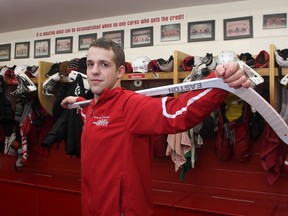 Andrew Hawkins, a fourth-year Royal Military College officer cadet and centre on the RMC men’s hockey team, in the club’s dressing room at the Constantine Arena. (Ian MacAlpine The Whig-Standard)