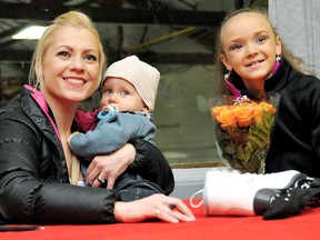 Shae-Lynn Bourne holds her eight-month-old son, Kai, while posing with Kaitlyn Marianchuck at East Kent Memorial Arena on Sunday after the Ridgetown Figure Skating Club carnival. (MARK MALONE/The Daily News)