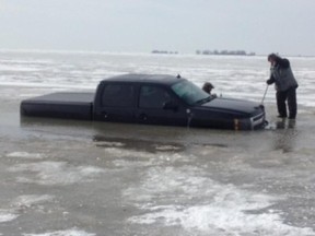 A 2009 Chevrolet Silverado was parked about 500 metres off-shore at Mitchell's Bay while the owner was ice fishing nearby when it fell through the ice. (Special to QMI Agency)