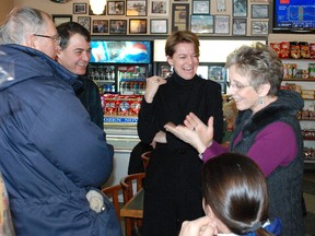 Famous cartoonist Lynn Johnston, right, speaks with federal Liberal leadership candidate Martha Hall Findley, second from right, and former Nipissing-Timiskaming MP Anthony Rota, second from left, during a visit to Demarco's, Monday.
