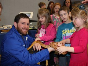 David Legros of Science North gave kids a hands-on experience with a corn snake during the The NorthernTel Kids carnival on Monday at Northern College in Kirkland Lake