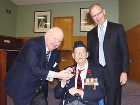 STEPHEN UHLER   Dr. Stuart Taylor, Royal Canadian Navy veteran, life member of the Legion, and long-time local philanthropist was presented a Queen Elizabeth II Diamond Jubilee Medal to recognize his lifetime of work to make his community a better place during a special ceremony held Saturday at Branch 72 of the Royal Canadian Legion. Here, Senator Mike Duffy, left, presents the medal to Dr. Taylor, while his son Gordon Taylor stands beside them.