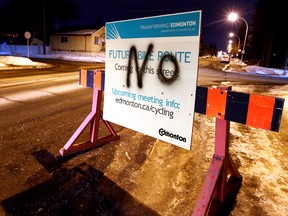 A defaced City of Edmonton sign along 76 Avenue near 97 Street, advises residents that the avenue is slated for a future bike route, in Edmonton, Alta. on Thursday, Feb. 14, 2013. David Bloom/Edmonton Sun/QMI Agency