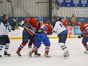 Game 4 of the first round of playoffs began to get heated in the third period as many of Mapleton-Minto 81's players were getting frusturated with the lopsided score. Pictured is 81's captain Matt McCann instigating a scuffle between 81's player Devin Richardson and Steve Shields of the Winterhawks.