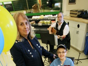 Aiden VanGulk’s (right) goal of fundraising for a worthy cause was supported by his grandma Judy (left) and musician Mark Hasson (rear). The trio set up an information/fundraising booth at the entrance to Zehrs Saturday, helping boost Aiden’s initial efforts to a final contribution of $585 to The Children’s Wish Foundation. Jeff Tribe/Tillsonburg News