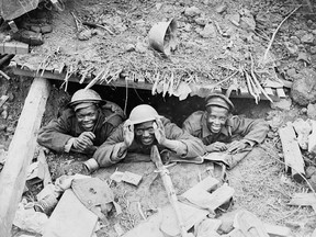 Three black soldiers in a German dugout captured during the Canadian advance east of Arras, from the collection of Library and Archives Canada.