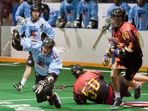 BOB TYMCZYSZYN, QMI Agency

Andrew Tober of the Lock Monsters is upended by Holden Vyse of the Demons in Monday's Canadian Lacrosse League game.