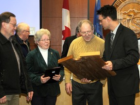 Jim and Sharon Brooks join Randy Repka (son of George Repka), left, and Mayor Bill Given, right, to receive the annual George Repka Award in council chambers at City Hall Tuesday. The Brooks' were presented with the award for their volunteer work with the Grande Prairie Museum and Grande Prairie Little Theatre. ADAM JACKSON/DAILY HERALD-TRIBUNE