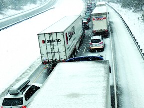 Minutes after a collision involving a tractor trailer blocked westbound lanes on Highway 401 near Mallorytown on Tuesday afternoon, traffic began to stack up to the east as heavy snow continued to fall. DARCY CHEEK The Recorder and Times