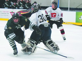 Gananoque Islanders goaltender Ryan Kazuba comes out to play the puck against the Westport Rideaus' Cameron McNutt during the second period of play. The Islanders hosted the Westport Rideaus for Game 3 in Junior B playoff action at the Lou Jeffries Recreation Centre on Sunday.