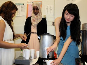 From left: J. Percy Page Grade 12 student Jereecah Dela Cruz buys a coffee from Ikram Osman and Ruby Yang to support the high school’s KIVA microloans fundraiser on Valentine’s Day.