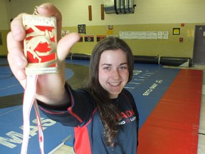 Gracelynn Doogan, of Elliot Lake, shows off her second national wrestling championship medal she won at a competition in Fredericton, New Brunswick in April. Gracelynn hopes the IOC will change its mind about dropping wrestling from the Olympic Games in 2020, in which it is her dream to compete. 				    
File photo