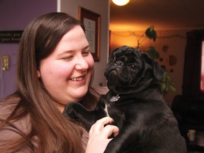 Lisa Meade comforts her pug, Luna, one of her present “babies.” Meade and her husband are unable to have children and hopes by speaking out that the province will change their current health care coverage plans for fertility treatments.
TESSA CLAYTON/AIRDRIE ECHO