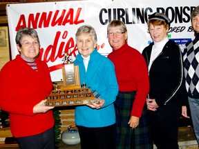 Sandi Coombs convener of the Real Canadian Superstore’s 23rd annual bonspiel presents the trophy to the winning team skipped by Ollie Sullivan.  Playing vice is Liz Tofflemire, second Shawn Whittaker and lead Marja Southherst. A total of $548 was raised for the President’s Choice Children’s Charity. (Submitted photo)