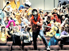 Cole Roe, 15, leads the St. Clair College Capitol Theatre Harlem Shake video on Wednesday night. Over eighty people of all ages showed up in costumes and with props to take part in the video shoot.(DIANA MARTIN, The Chatham Daily News)