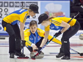 Andrew Klaver Photography
Amber Cheveldave (left) and second Michelle Dykstra, sporting fashionable caps, sweep for Kristie Moore at the Scotties in Kingston, Ont.