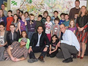 Wild Rose MP Blake Richards, seated centre, joins to crew at the Cochrane and Area Boys and Girls Club after announcing over $25,000 in funding through the Community Infrastructure Improvement Fund.