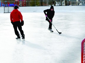 Jamie Barrett, right, tries to get past Pat Froom during a game of one-on-one hockey at the Rotary pad on Wednesday.  RONALD ZAJAC The Recorder and Times