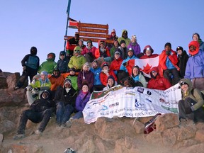 Project Kenya volunteers celebrate reaching the summit of Mount Kenya recently, as part of a leadership development trip to Kenya for high school students. Participants also went on a one-day safari and helped build a school kitchen. (Submitted photo)