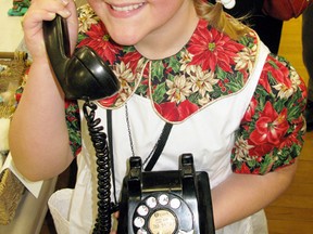 Claryssa Radzick, 9, of Selkirk holds an antique phone during the village's annual Heritage Day celebrations held on Monday, Feb. 18. Hundreds of people packed Selkirk's community centre for the event, which celebrated the area's history. It included food, live music, and displays.
