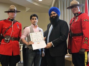 Mike Zouhri, 26, centre left, was one of 25 Edmonton-area residents to be presented with the Queen’s Diamond Jubilee medals by Edmonton-Sherwood Park MP Tim Uppal, centre right, at the Sherwood Park council chambers on Jan. 24. PHOTO SUPPLIED Office of Tim Uppal