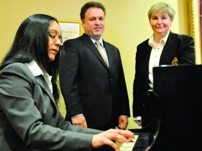 Samia O'Day, a Brockville Concert Association board member and chairman of the 1000 Islands Jazz and Blues Festival, performs Chopin's Etude in F minor on the Brockville Arts Centre lobby piano while Leeds-Grenville MP Gord Brown and concert association president Marie-Helene Bouillot listen on Wednesday. RONALD ZAJAC The Recorder and Times