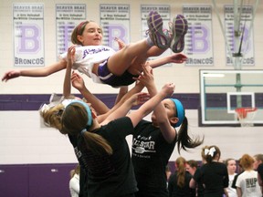 Girls from the youth squad of Kenora All Star Cheer and Dance practice their baskets while the Beaver Brae high school cheer team practices in the background.
GRACE PROTOPAPAS/Daily Miner and News