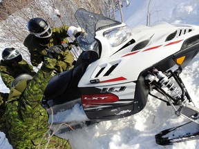 Capt. Bob Munroe, right, from Public Affairs helps troops dig out a snowmobile during a patrol near Moosonee as part of Exercise TRILLIUM RESPONSE. The exercise was Joint Task Force Central’s annual field training exercise aimed at developing and maintaining the capability and expertise to conduct various operations in remote areas and austere conditions. This year’s exercise focused on a Defence of Canada scenario in a remote area of Northern Ontario. The exercise is provided challenging training to Canadian Army and Royal Canadian Air Force personnel, allowing them to regenerate winter field skills operating in harsh weather conditions.