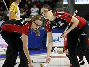Team Ontario's Alison Kreviazuk and Lisa Weagle sweep a rock during Thursday's action at the Scotties Tournament of Hearts.