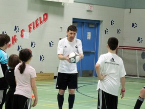 John Clubb, provincial soccer coach for southern Alberta, explains a drill to some youth soccer players Wednesday night at the Father Turcotte school gym.  TREVOR HOWLETT/TODAY STAFF