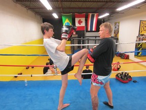 Submitted Photo

Fifteen-year-old fighter Bailey Castledine (left)  and Kru Todd Whetter practise long knees at Caged Dragon on Copernicus Boulevard. Caged Dragon is hosting a Muay Thai card Saturday at Mohawk College.