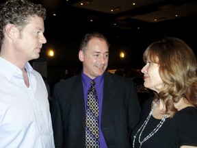 Geoff Wright, left, of Chatham-Kent Economic Development and Dean Muharrem, publisher of digital and print for The Chatham Daily News discuss successful business traits with television personality Dianne Buckner, prior to her speech Thursday. (BOB BOUGHNER/QMI Agency)