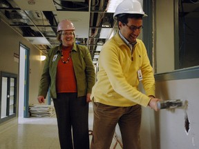 Dr. Giuseppe Guaiana, St. Thomas-Elgin General Hospital psychiatry chief, takes a hammer to a wall in STEGH's under-construction interim mental health unit while mental health care program manager Deb Gibson watches in amusement. STEGH anticipates moving mental health services to the new area from Regional Mental Health Care, St. Thomas this fall.