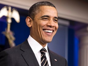 U.S. President Barack Obama smiles during a technical problem from a camera man as he calls on Congress to pass a small package of spending cuts and tax reforms that would delay the larger, automatic "sequester" cuts from going into effect during an announcement in the White House briefing room in Washington February 5, 2013. (REUTERS/Joshua Roberts)