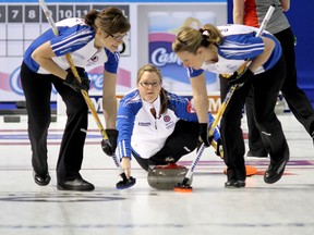 Team British Columbia's skip Kelly Scott watches her stone as lead Sarah Wazney (left) and third Jeanna Schraeder sweep against the Northwest Territories/Yukon as they compete in the Scotties Tournament of Hearts in Kingston at the K-Rock Centre on Friday February 22 2013. (IAN MACALPINE, QMI Agency)