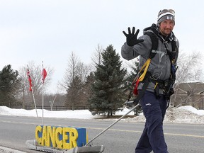 Mike Duhacek of Milton walks along county road two west of Odessa as he walks while pulling a 56 kilogram sled from Windsor to Ottawa to raise money to battle cancer.
Ian MacAlpine The Whig-Standard