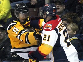 Sarnia Sting forward Brett Hargrave, left, takes a shot from former teammate and current Erie Otters defenceman Jack Kuzmyk Friday, Feb. 22, 2013 at the RBC Centre in Sarnia, Ont. (PAUL OWEN, The Observer)