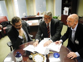MPP Dave Levac (centre) and Andrew McRobert (right), director of mental health and addictions at the Brant Healthcase System, hand over files and research on a potential detoxification and rehabilitation centre for the area to Mayor Chris Friel earlier this year. (SUSAN GAMBLE The Expositor)