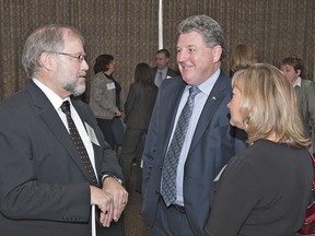 David Johnston (left), general manager of economic development and strategic investment for the County of Brant, chats with Brant MP Phil McColeman and his chief of staff Teresa Percival following the MP and MPP's breakfast on Friday morning at the Best Western in Brantford. (BRIAN THOMPSON The Expositor)