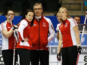 Team Canada skip Heather Nedohin looks on during a timeout with teammates Jessica Mair, left, coach Darryl Horne, Laine Peters, second from the right, and Beth Iskiw Friday at the Scotties Tournament of Hearts in Kingston, Ont.    (REUTERS)