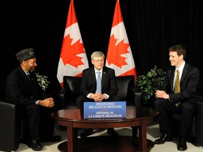 Prime Minister Stephen Harper meets with Andrew Bennett, right, and Lal Khan Malik, the national president of Ahmadiyya Muslims Jama'at Canada, on Tuesday at the Aiwan Tahir Community Centre in Maple, Ont. Harper formally announced the establishment of the Office of Religious Freedom and the appointment of Bennett as its ambassador.